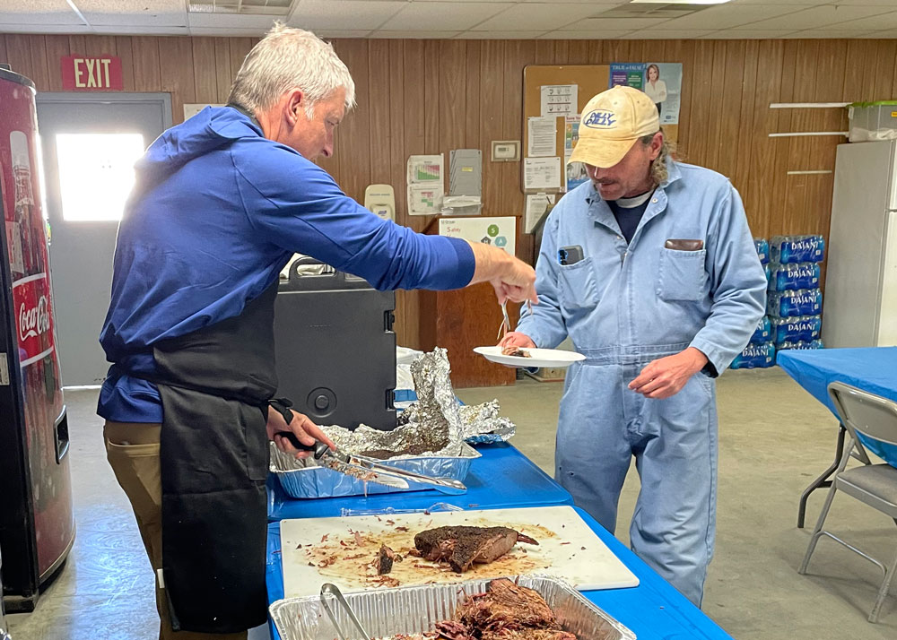 Thompson leadership team serving meals to construction workers.